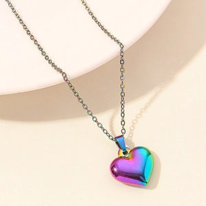 Macro view of a 3D heart necklace with a vibrant rainbow gradient plating on a metal chain
