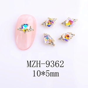 Detailed view of aurora heart nail gems with 10x5mm gold setting and small rhinestones