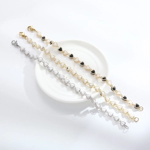 Detail of heart-linked bracelets with pearls and enamel in gold and silver finishes