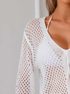 Close-up of white hollow knit cardigan featuring honeycomb mesh texture and V-neck tie detail