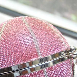 Detail of pink rhinestone basketball evening bag with silver metal frame and crystal stripes