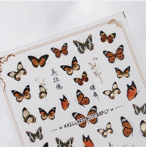Detail of Maillard butterfly nail stickers featuring realistic art and calligraphy