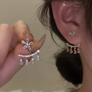 Detail of floral zircon earrings with a two-way wear design in gold-plated finish