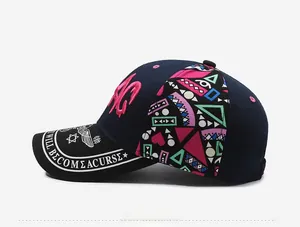 Detail of navy baseball cap featuring pink 3D embroidery and printed brim text