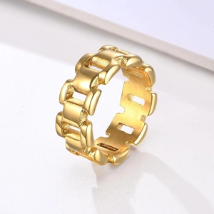 Detailed close-up of golden chain link ring with polished finish on white background