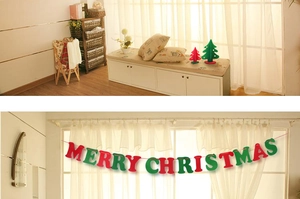 Close-up of festive felt Merry Christmas banner and 3D tabletop Christmas trees