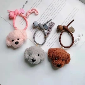 Three plush teddy dog charms in pink grey and brown with spiral cords and bells