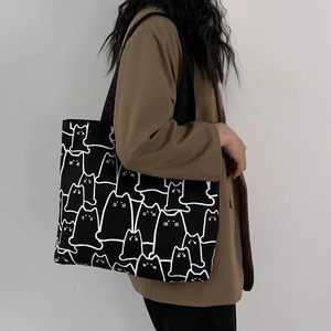 Canvas tote bag detail showing the minimalist black and white cat pattern print