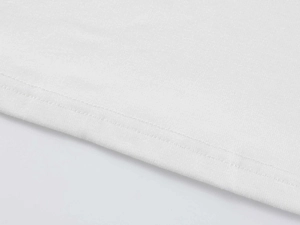 Macro shot of double-needle stitching on the hem of a white modal slim-fit sports T-shirt
