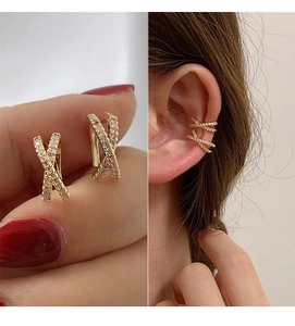 Detail of gold-plated X-shape ear cuffs with micro-paved zircons and wearing demonstration