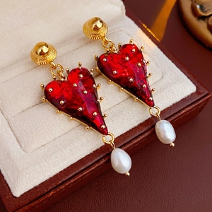 Vintage gold heart studs with red resin and white teardrop pearls on velvet