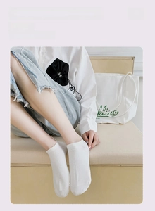 Close-up of white breathable cotton low cut invisible socks with heel embroidery