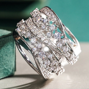 Macro shot of multilayer crisscross silver ring with sparkling crystal pave setting