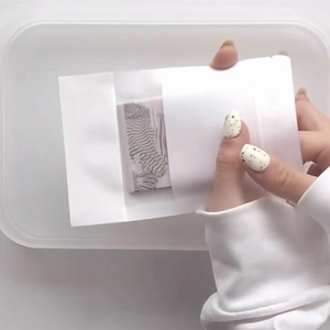 Detail view of white semi-transparent gift bag with zebra pattern stickers inside