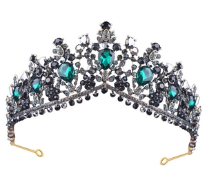 Detail of dark metal bridal crown featuring emerald green crystals and black gemstones