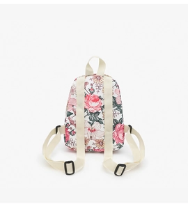 Detail of floral mini backpack showing adjustable cream straps and plastic buckles