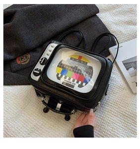 Macro shot of retro black TV shaped backpack with NO SIGNAL pattern and silver buttons