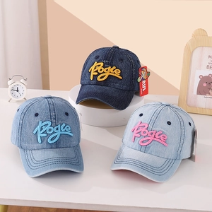 Detailed view of three denim kids baseball caps with colorful Pogie embroidery