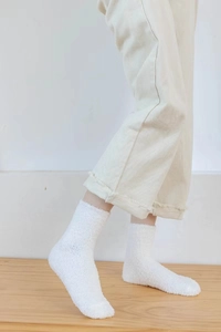 Detailed close-up showing the soft plush texture of white coral fleece winter socks