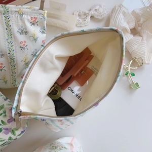 Detailed interior of a floral canvas makeup bag with smooth zipper and ample storage