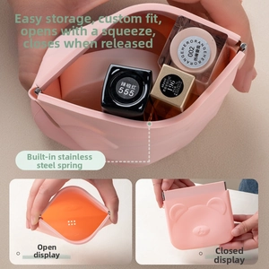 Detail view of pink silicone pouch showing squeeze opening and internal steel spring clip