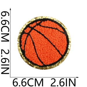 Macro detail of basketball chenille patch with orange loops and gold sequin edges