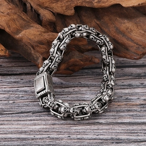 Detail of vintage silver skull links on a gothic punk stainless steel bracelet