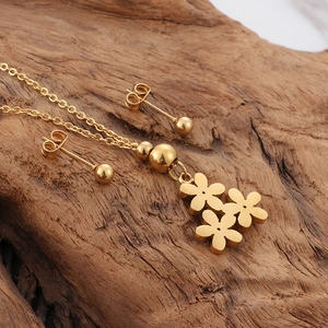Golden titanium steel jewelry set featuring daisy flower necklace and stud earrings