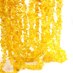 Macro shot of semi-transparent irregular yellow stone beads for DIY jewelry making