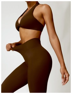 Detail showing the stretch and elasticity of the chocolate brown yoga set fabric