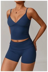Detail of high-stretch navy blue V-neck yoga tank top and high-waist fitness shorts set