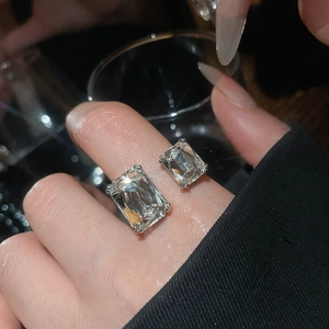 Close-up of geometric open ring featuring two radiant-cut clear cubic zirconia stones