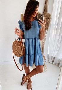 Detail of blue denim dress featuring tiered ruffle hem and short flutter sleeves