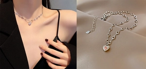 Detail of silver heart necklace with pink gemstone and hollow heart chain links