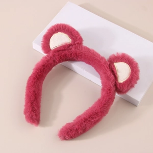 Detailed plush texture of a deep pink teddy bear headband on a clean white display stand