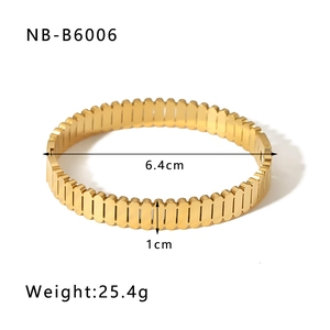 Detail view of gold gear-textured stainless steel bangle with dimensions and weight stats