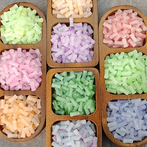 Multi-colored 6x12mm gradient bamboo glass beads in a wooden tray for DIY jewelry making