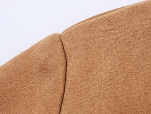 Close-up of brown suede fabric texture and stitching detail on the bomber jacket