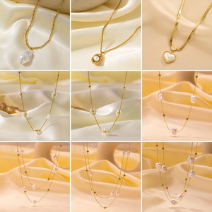 Detailed grid of baroque pearl necklaces and gold chains on creamy silk fabric