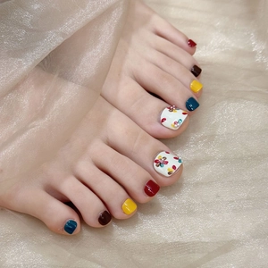 Colorful handmade press-on toenails with vibrant floral patterns and pearl 3D decorations