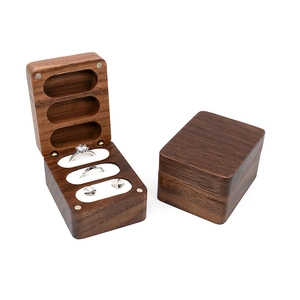 Detail of walnut wood ring box showing open and closed states with three slots