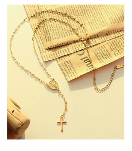 Detailed macro of 18K gold plated necklace with Virgin Mary medal and cross pendants