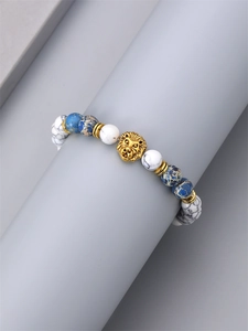 Men's emperor stone and white turquoise beaded bracelet featuring a gold lion head charm