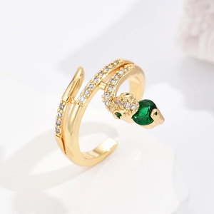 Detailed close-up of 18K gold-plated snake ring with emerald-green zircon head and white crystals