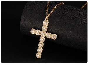 Macro shot of gold cross pendant featuring sparkling micro-paved cubic zirconia crystals