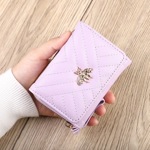 Lavender faux leather zip-around wallet with quilted pattern and gold bee detail