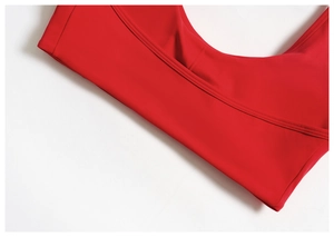 Detail of red sports bra showing high-stretch fabric and precise flatlock stitching