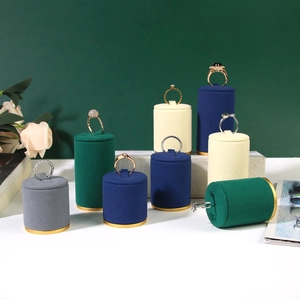 Velvet ring display stands with gold metal bases in grey green blue and beige tones