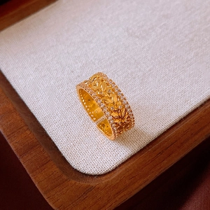 Macro shot of gold plated leaf ring with sparkling crystals and fine texture