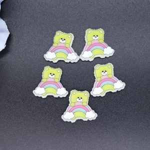 Macro detail of five resin cartoon bears on rainbows for DIY phone case and hair crafts